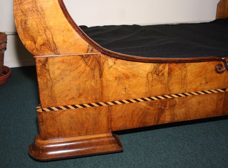   This is a Rosewood sleigh bed circa 1870 in the Napoleonic style. It has extensive ebony and satin wood inlays. The bed is in pristine condition with rich and warm rosewood construction. It has a new and unused custom made mattress and box springs